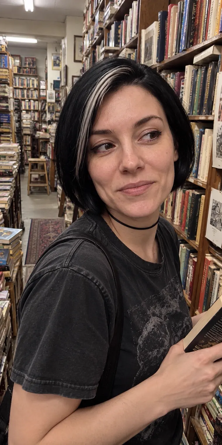 Vesper browsing the shelves in a bookshop